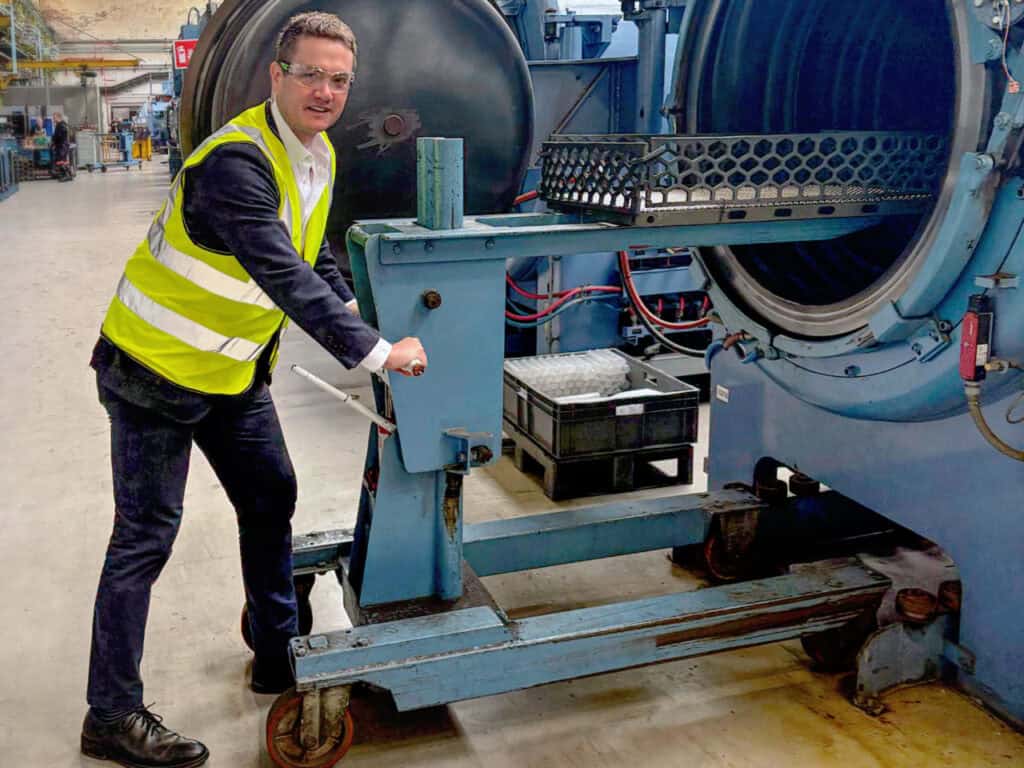 James Frith, MP for Bury North, loading a furnace at Wallwork Heat Treatment